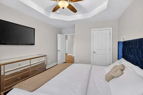 a bedroom with a bed and a flat screen tv