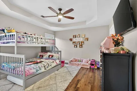 a bedroom with a bed and a chandelier