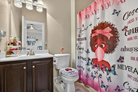 a bathroom with a sink mirror and toilet