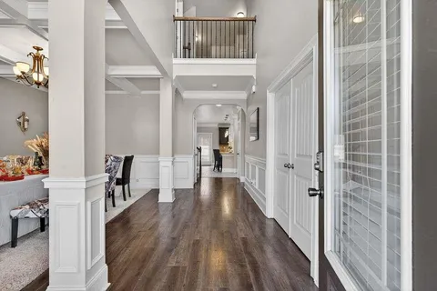 a view of a hallway view with wooden floor and furniture