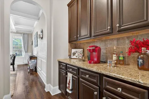 a kitchen with granite countertop cabinets and wooden floor