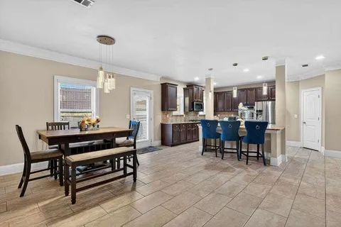 a living room with dining room and kitchen view