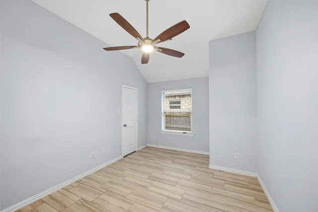 a view of a livingroom with a ceiling fan and wooden floor