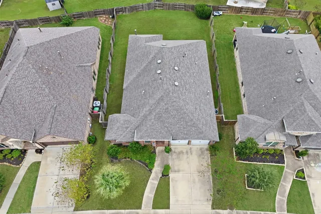 an aerial view of a house with a garden and a yard