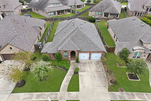 an aerial view of a house with a yard