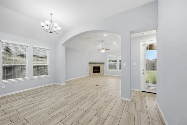 a big room with windows and chandelier