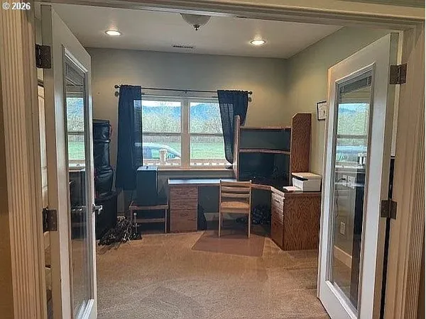 a room with furniture a flat screen tv and windows