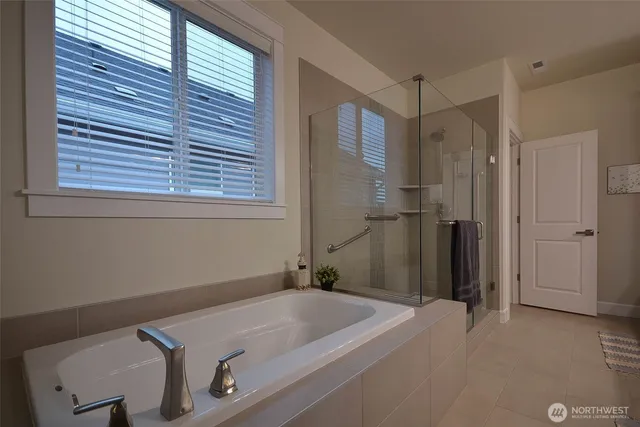 a bathroom with a tub and a window