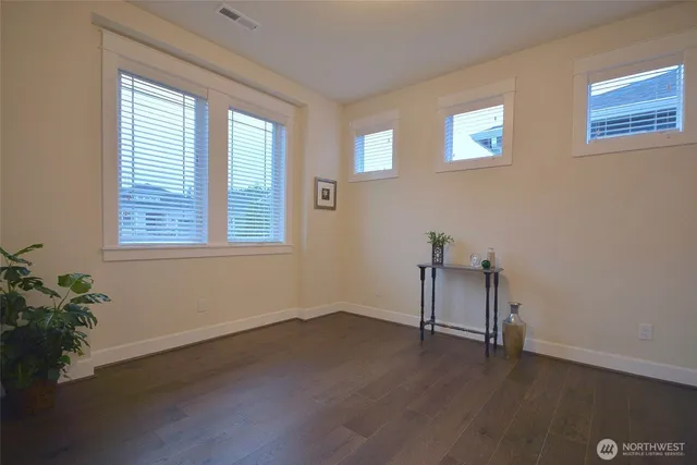 a view of a room with wooden floor and a window