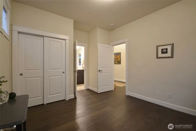an empty room with wooden floor and closet