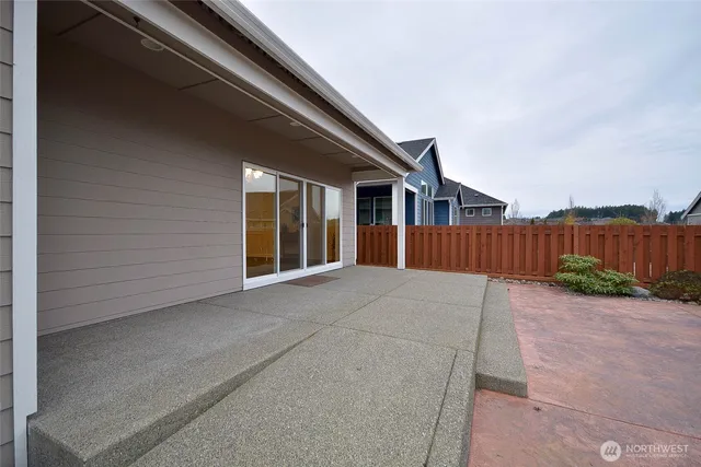 a view of a house with wooden fence