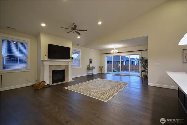 a living room with fireplace furniture and a flat screen tv