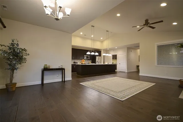 a view of a room with kitchen and chandelier