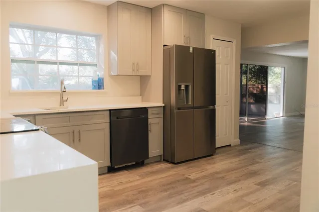 a kitchen with stainless steel appliances a refrigerator and a sink