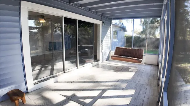 a room with window and a glass door