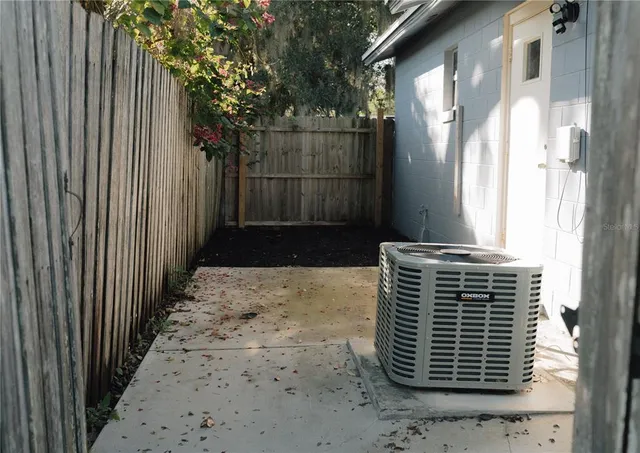 a view of a pathway of a house with wooden fence