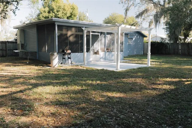 a backyard of a house with yard and barbeque oven