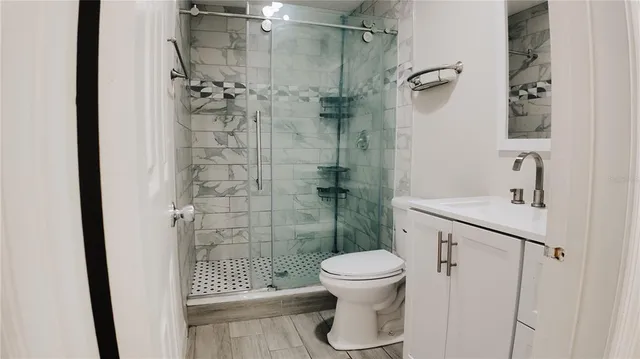 a bathroom with a shower toilet and sink