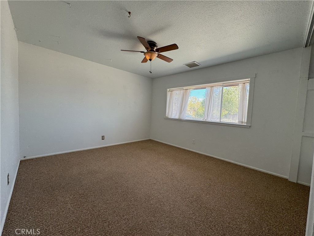 543 Weiman Avenue Ridgecrest, CA 93555 - Photo 14 of 37 an empty room with a window and a fan