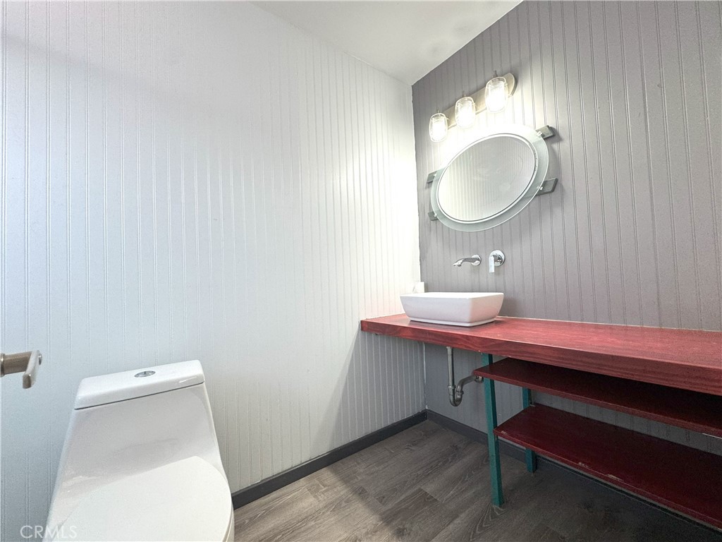 543 Weiman Avenue Ridgecrest, CA 93555 - Photo 21 of 37 a room with a toilet a sink and a mirror