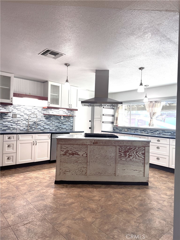 543 Weiman Avenue Ridgecrest, CA 93555 - Photo 33 of 37 a large kitchen with granite countertop a sink and a stove