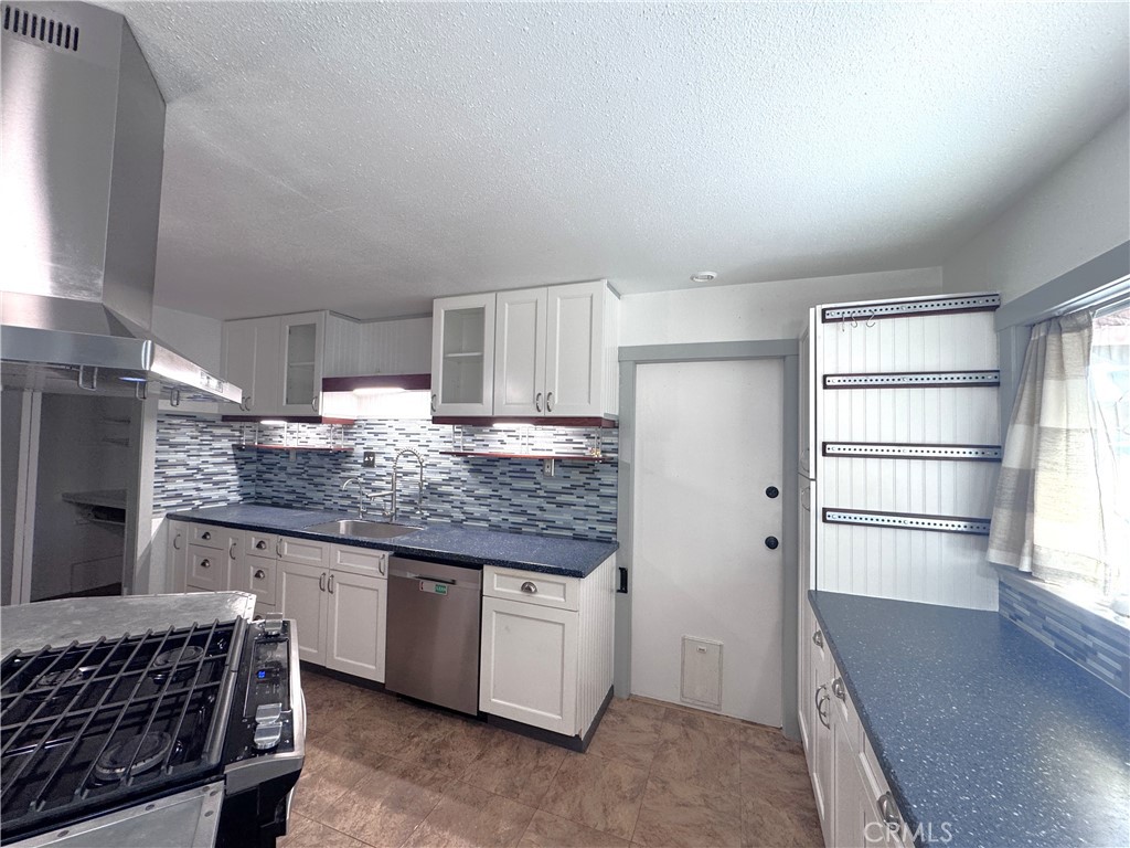 543 Weiman Avenue Ridgecrest, CA 93555 - Photo 35 of 37 a kitchen with granite countertop a sink stainless steel appliances and cabinets