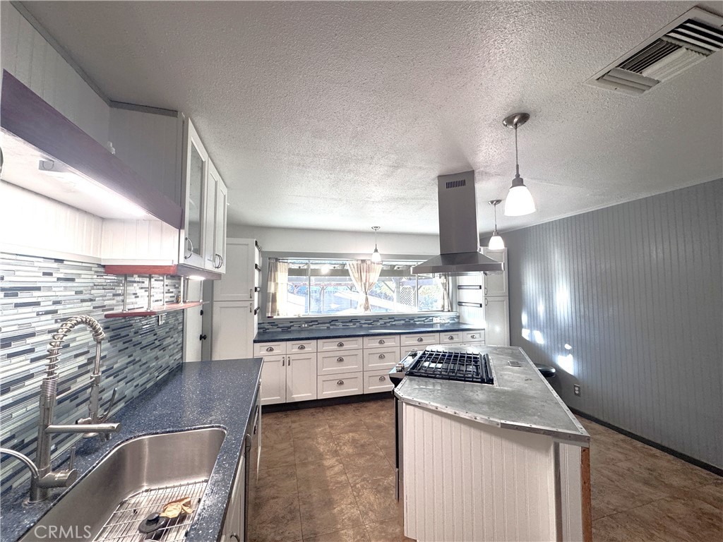 543 Weiman Avenue Ridgecrest, CA 93555 - Photo 36 of 37 a kitchen with stainless steel appliances granite countertop a sink a stove and a wooden floors