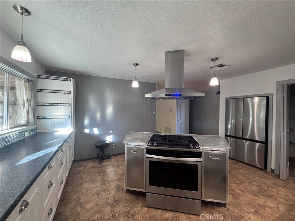 543 Weiman Avenue Ridgecrest, CA 93555 - Photo 37 of 37 a kitchen with stainless steel appliances a stove and a refrigerator