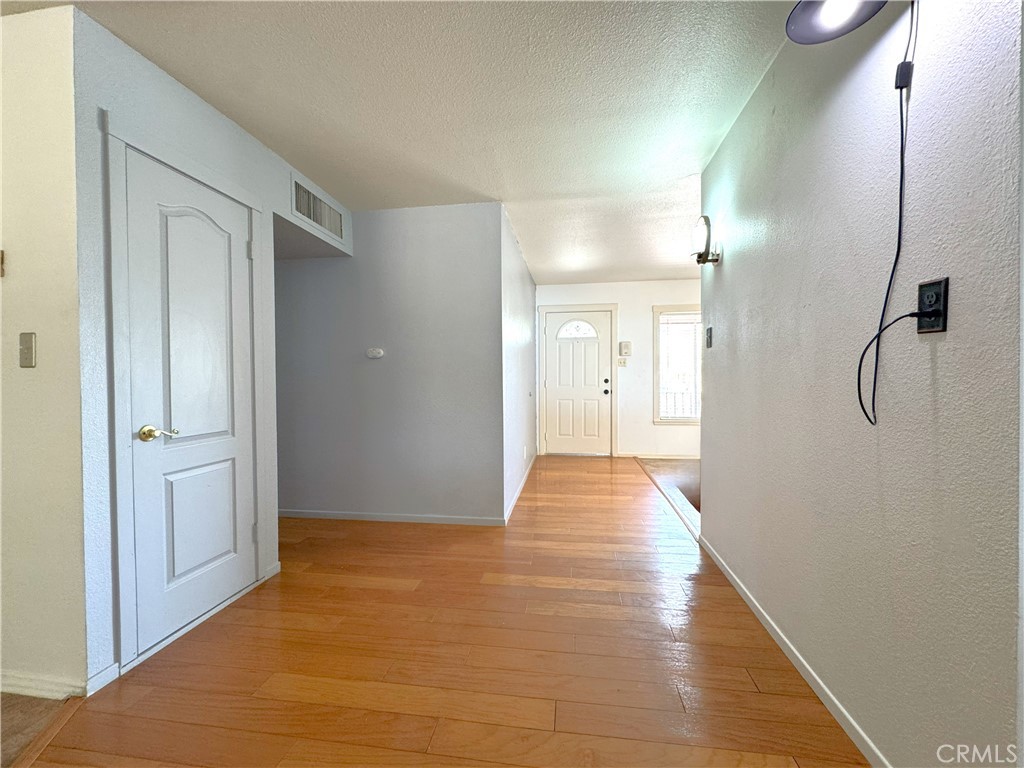 543 Weiman Avenue Ridgecrest, CA 93555 - Photo 9 of 37 a view of a hallway with wooden floor