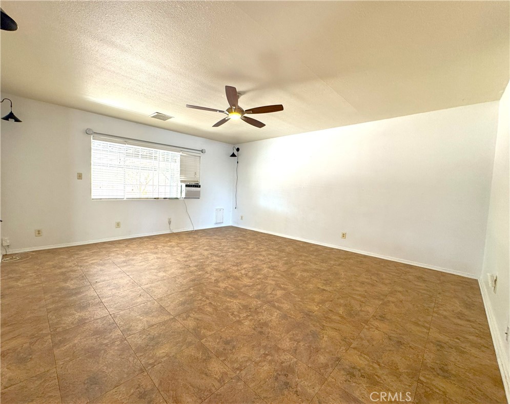 543 Weiman Avenue Ridgecrest, CA 93555 - Photo 10 of 37 an empty room with a ceiling fan and window