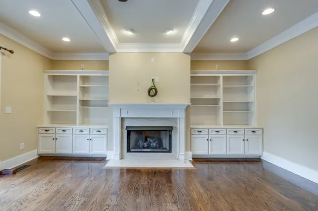 a view of a living room and kitchen with a ceiling fan