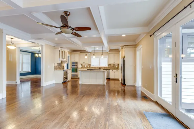 a kitchen with kitchen island a sink stainless steel appliances and cabinets