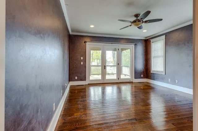 a view of room with window and wooden floor