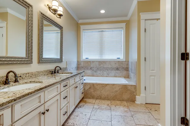 a bathroom with a shower a mirror and a sink