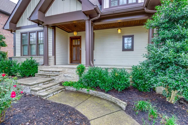 a front view of a house with plants