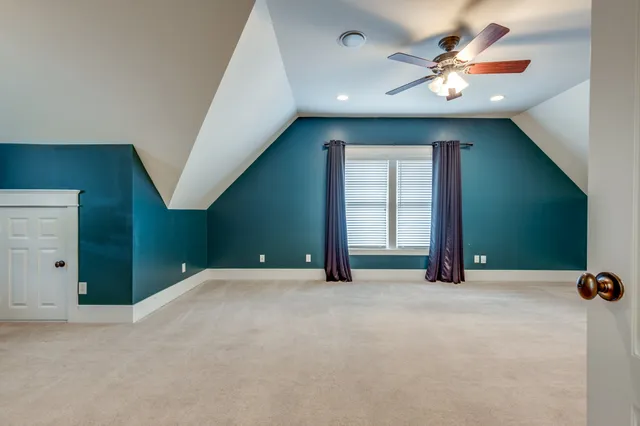 a view of a livingroom with a ceiling fan and window