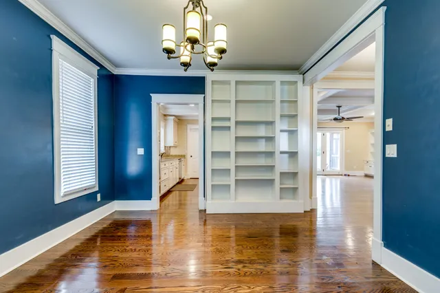 a view of a livingroom with wooden floor and a fireplace