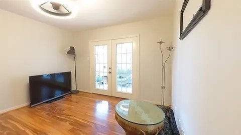 a view of a livingroom with furniture and hardwood floor
