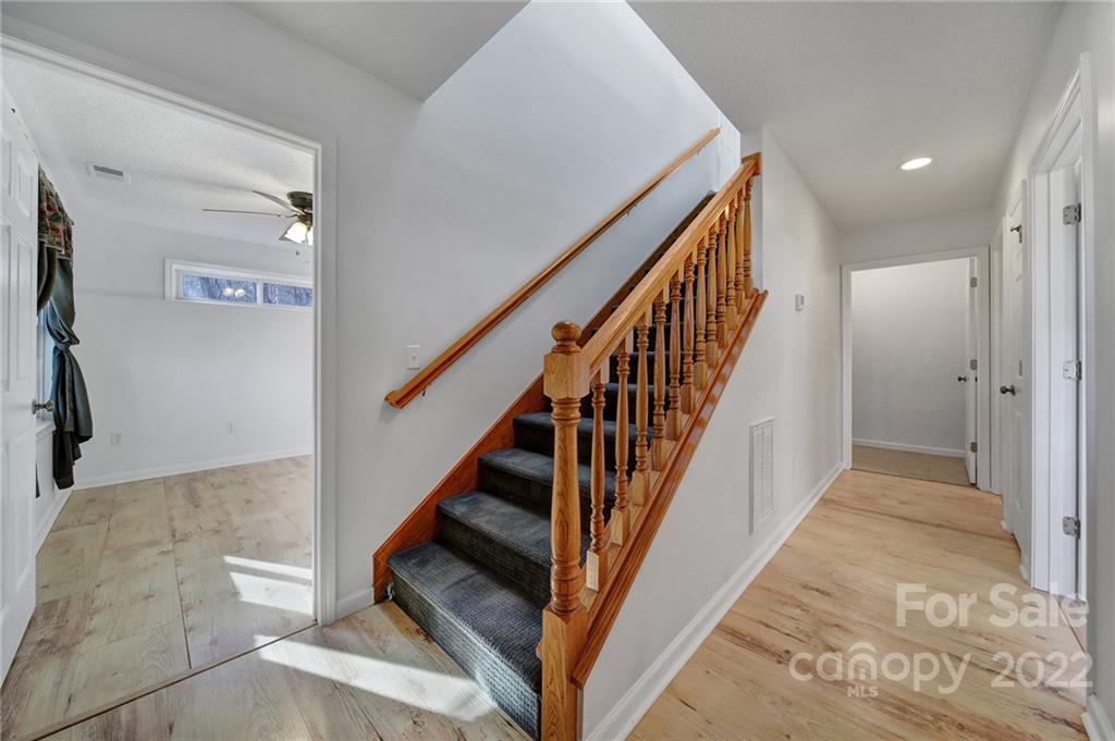 119 Celestial Way Mill Spring, NC 28756 - Photo 14 of 33 a view of staircase with wooden floor and fan