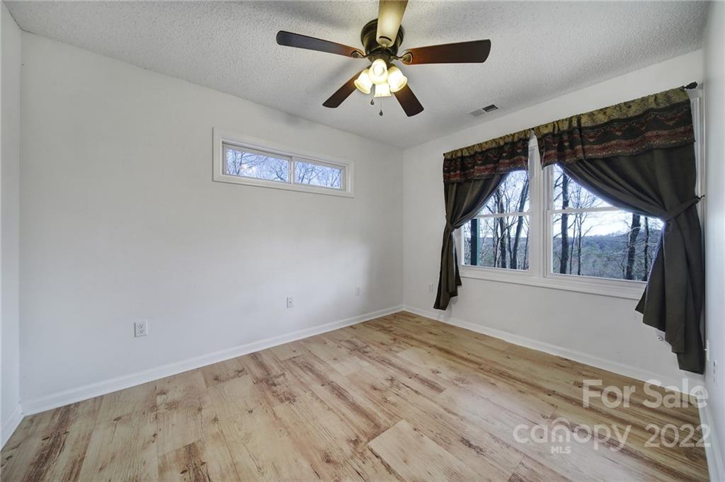 119 Celestial Way Mill Spring, NC 28756 - Photo 17 of 33 a view of empty room with wooden floor