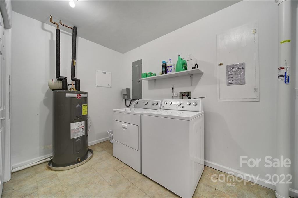 119 Celestial Way Mill Spring, NC 28756 - Photo 23 of 33 a utility room with cabinets washer and dryer