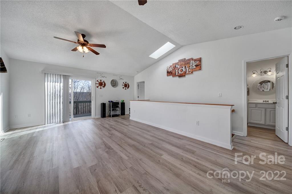 119 Celestial Way Mill Spring, NC 28756 - Photo 8 of 33 wooden floor in an empty room with a window