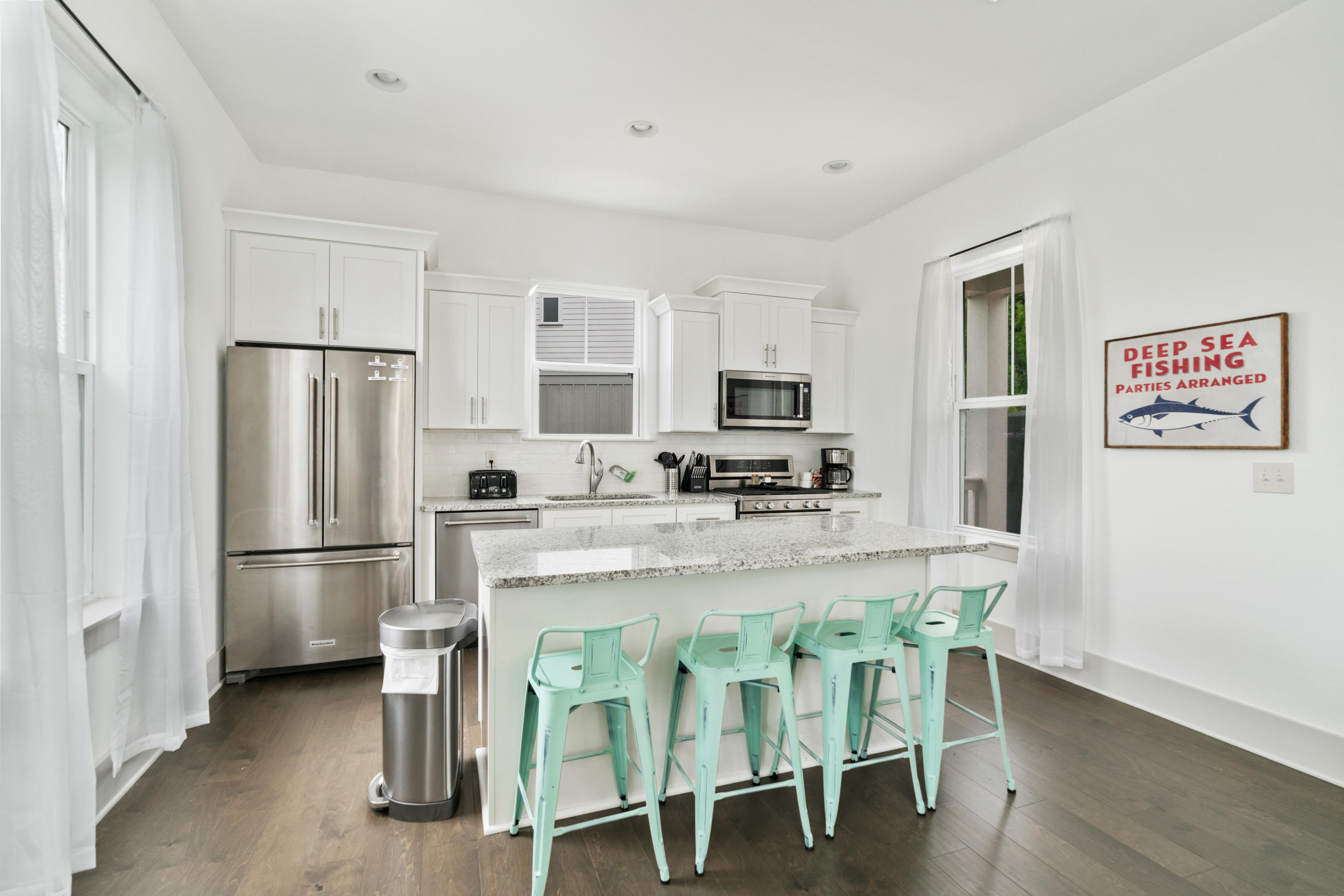 275 Gulfview Circle Santa Rosa Beach, FL 32459 - Photo 2 of 47 a kitchen with kitchen island a refrigerator stove microwave and cabinets