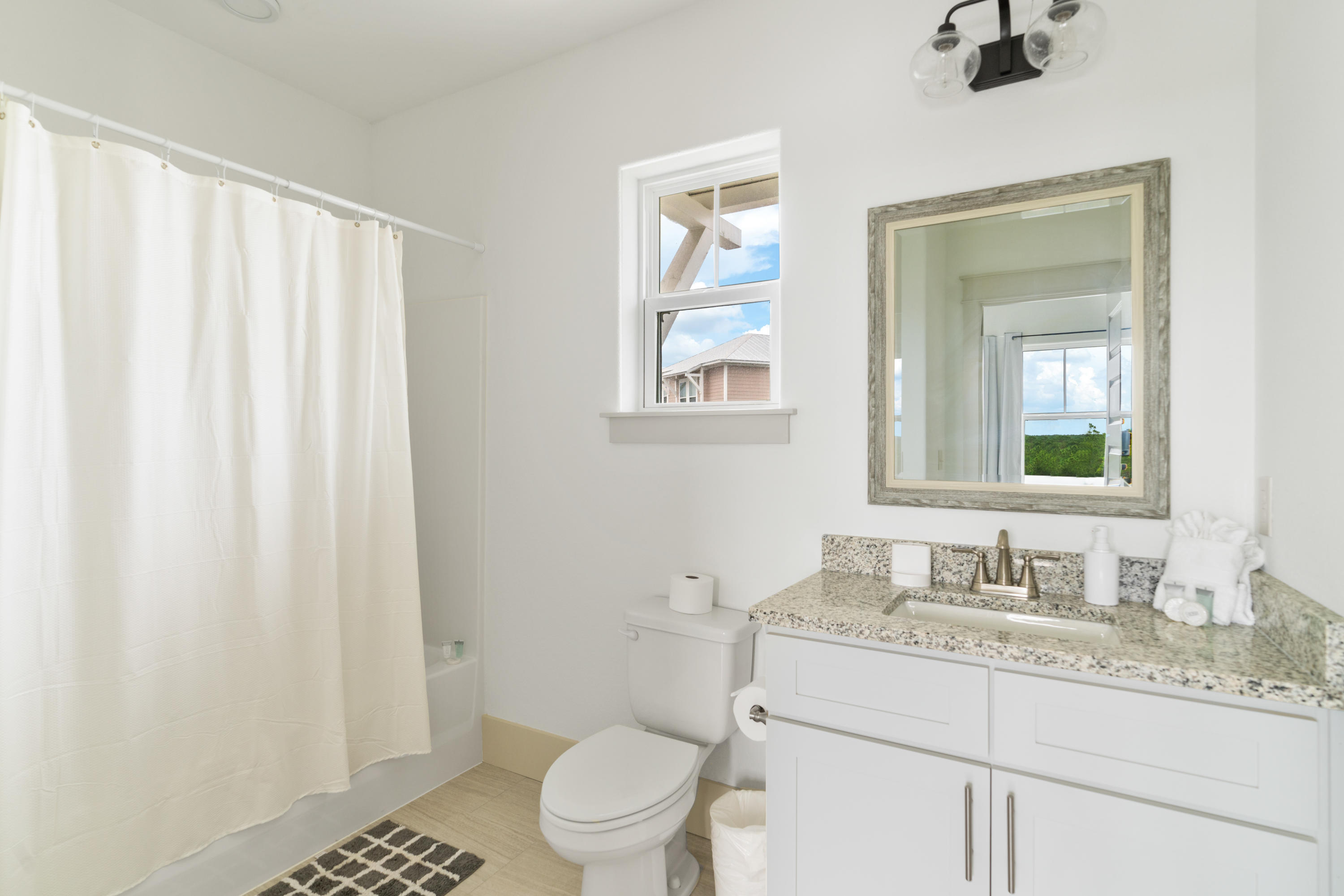 275 Gulfview Circle Santa Rosa Beach, FL 32459 - Photo 27 of 47 a bathroom with a granite countertop sink toilet and mirror