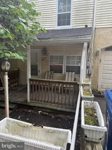 a view of a house with a wooden fence