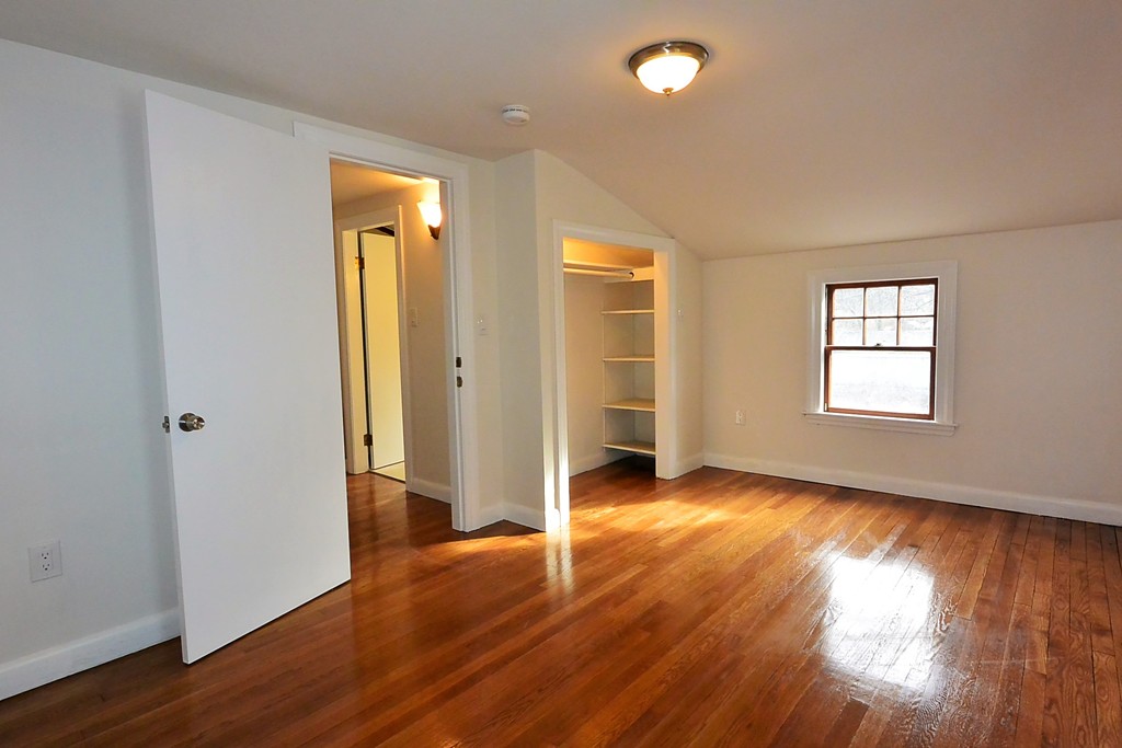 6 Arnold Road Peabody, MA 01960 - Photo 14 of 24 an empty room with wooden floor and windows