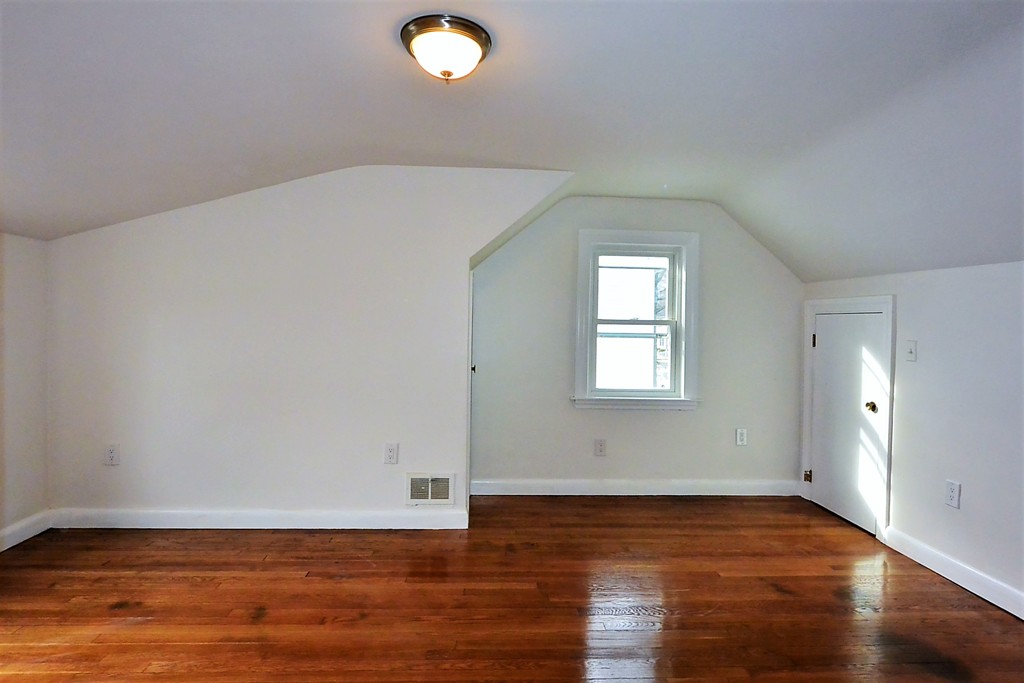 6 Arnold Road Peabody, MA 01960 - Photo 15 of 24 a view of an empty room with wooden floor and a window