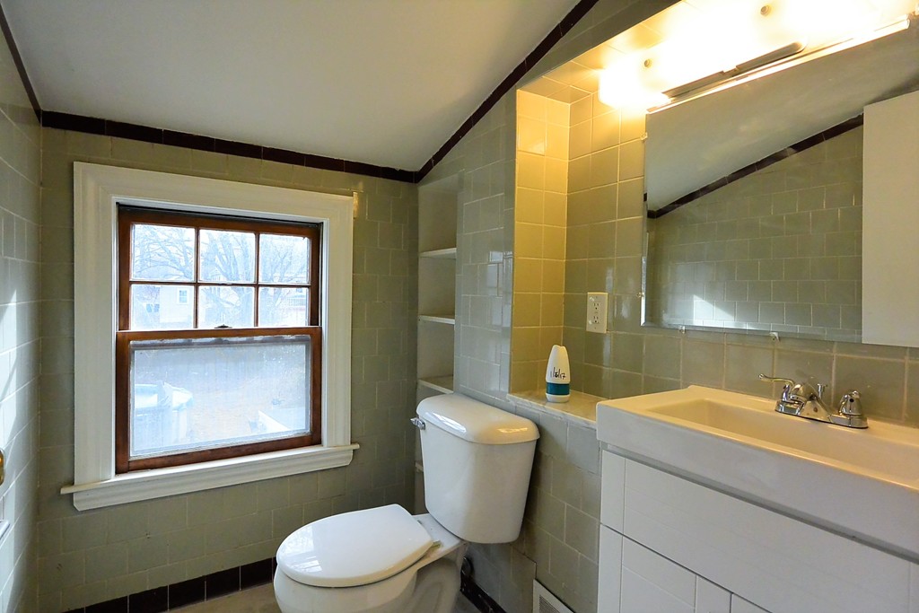 6 Arnold Road Peabody, MA 01960 - Photo 16 of 24 a bathroom with a granite countertop toilet a sink and mirror
