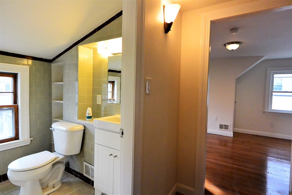 6 Arnold Road Peabody, MA 01960 - Photo 19 of 24 a bathroom with a toilet a sink and a mirror