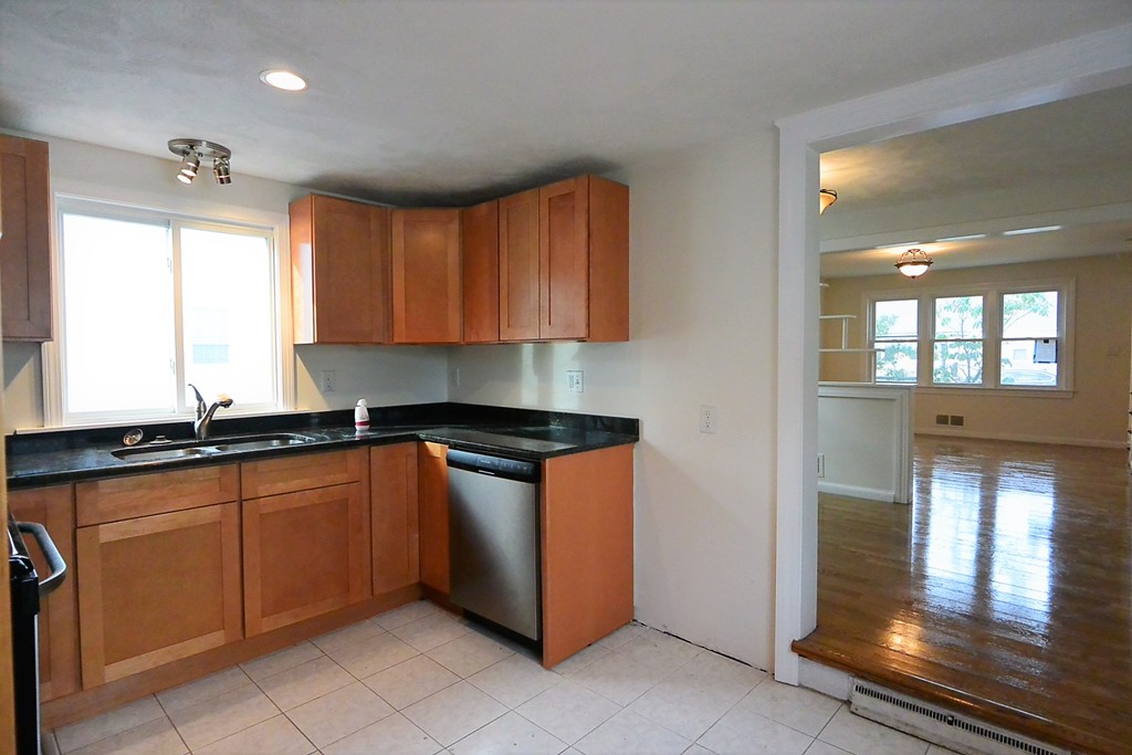 6 Arnold Road Peabody, MA 01960 - Photo 3 of 24 a kitchen with granite countertop a sink and cabinets